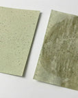 Two green tea oil blotting papers showing absorption strength of the paper
